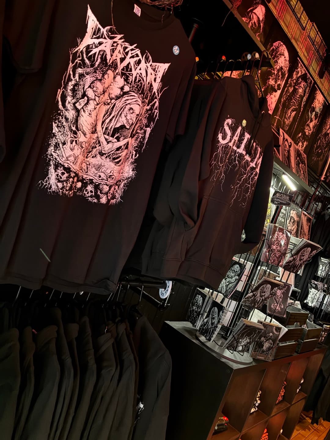 Apparel and prints on the racks inside Tomb Gallery in Salem